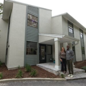business owners standing and smiling outside of building for Cereset Orlando
