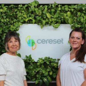 owner and staff in front of logo sign at Cereset Plano